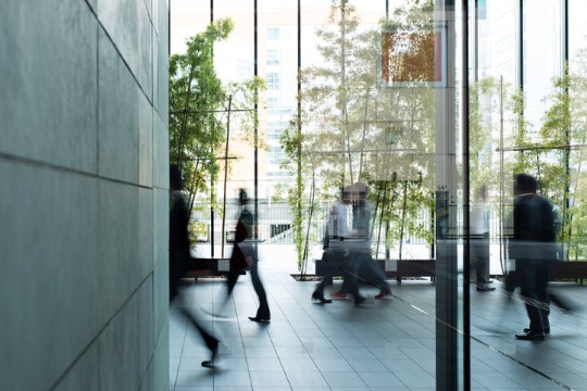 business-person-walking-in-a-urban-building 540x360